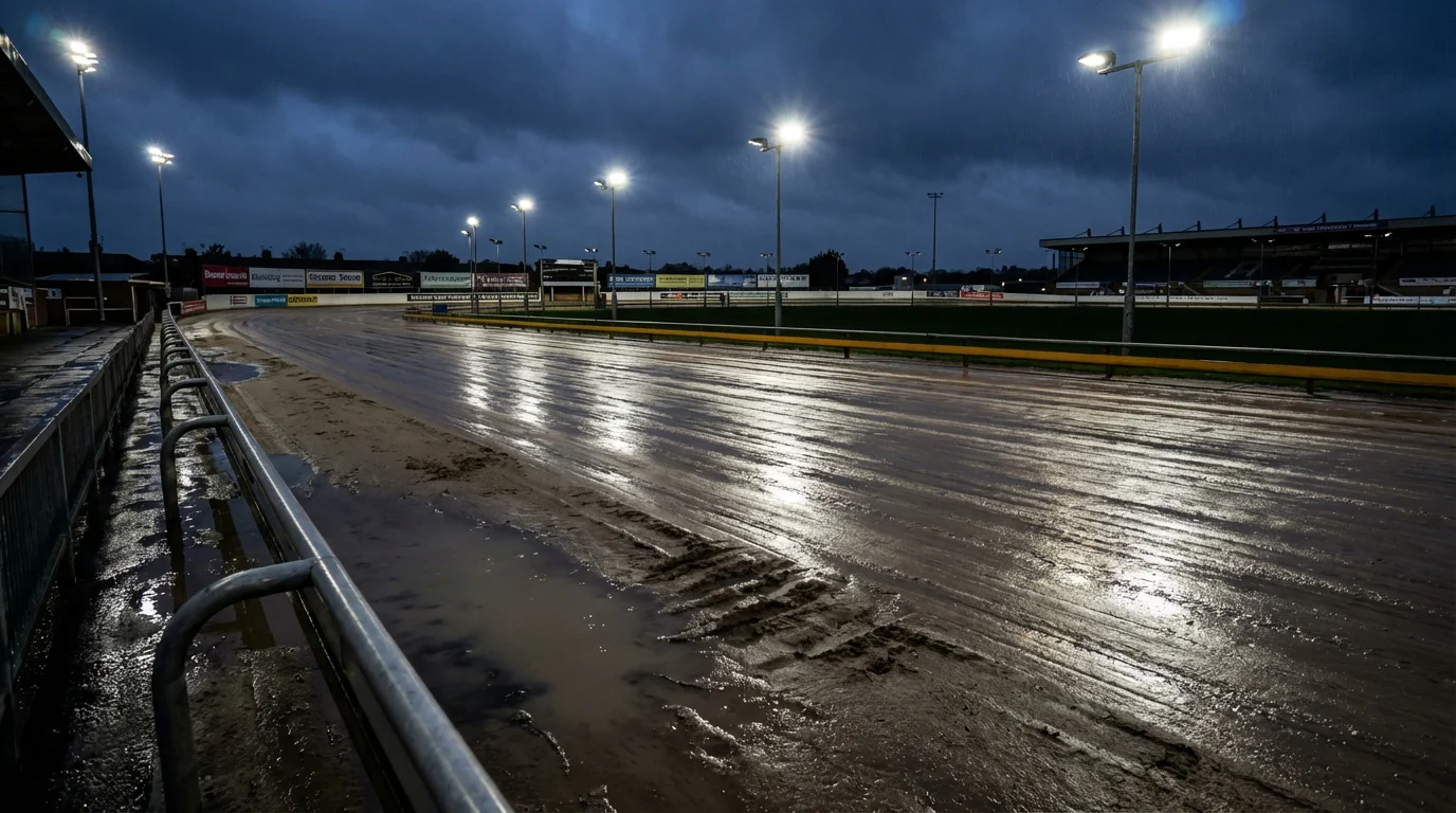 Wet greyhound racing track with reflections of floodlights on damp sand after rain